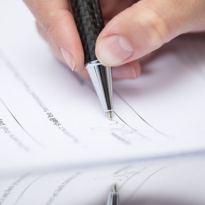 woman-signing-documents-2024-09-14-12-04-31-utc